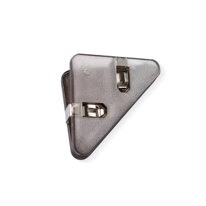 Close-up of translucent grey triangular corner clip for securing paper and documents