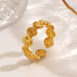 Golden shell-shaped stainless steel open ring with luxury lighting on white background