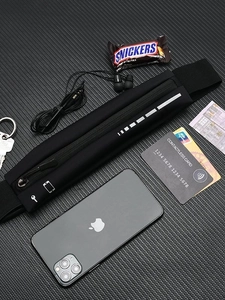 Slim waterproof sports waist pack with reflective strip shown with phone and keys