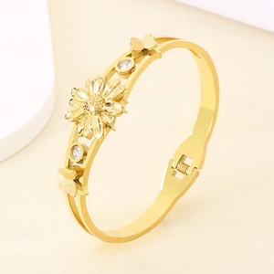 Bracelet en acier doré avec motifs de marguerites et papillons ornés de strass brillants