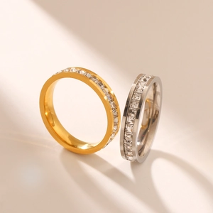 Close-up of gold and silver titanium steel rings with square-cut cubic zirconia stones