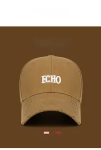 Detail of vintage brown baseball cap with white ECHO embroidery and distressed brim