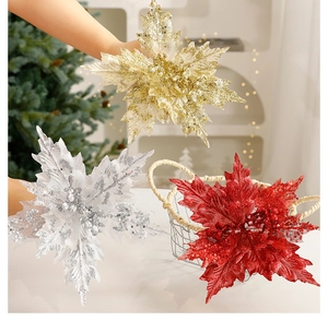 Detail of glittered Christmas poinsettia flowers in gold, silver and red for tree decor