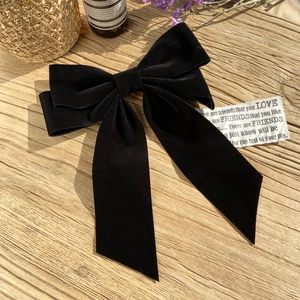 Elegant black velvet bow hair clip with long tails for weddings and formal styling