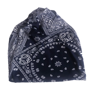 Detailed view of dark blue paisley pattern on soft knit fabric of the slouchy beanie hat
