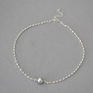 Detail of silver bead chain necklace featuring a grey pearl with adjustable lobster clasp
