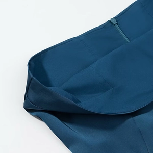 Detail shot of invisible zipper and seam work on deep blue satin vacation dress