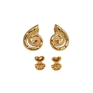 Macro detail of golden snail spiral earrings featuring colorful inlaid zircon gemstones