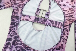 Detailed back view showing the cutout design and metal buckle on purple leopard jumpsuit