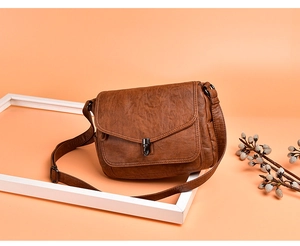 Caramel brown vintage shoulder bag featuring retro lychee grain leather and metal twist lock
