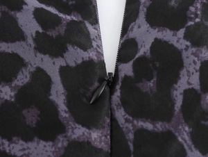 Detail view of the hidden back zipper on dark leopard print organza maxi dress