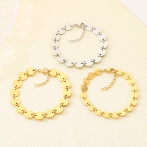 Detail of round disc link bracelets in gold and silver finish with lobster clasp and chain