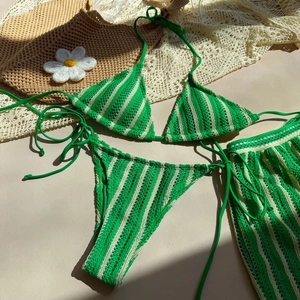 Close-up of green striped crochet bikini set with matching beach skirt detail