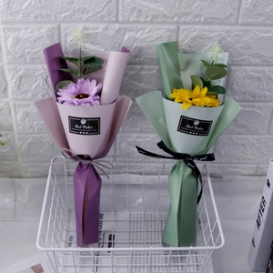 Detail of artificial sunflower bouquets in purple and yellow with Best Wishes gift wrap