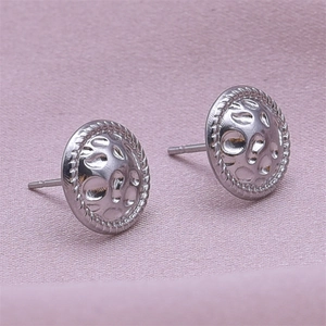 Macro shot of silver bow stud earrings with hammered 304 stainless steel texture