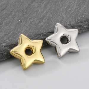 Detailed view of star-shaped stainless steel charms in gold and silver finishes
