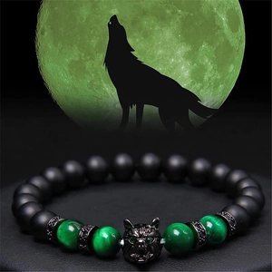 Detailed wolf head charm on beaded bracelet with black matte and green tiger eye stones