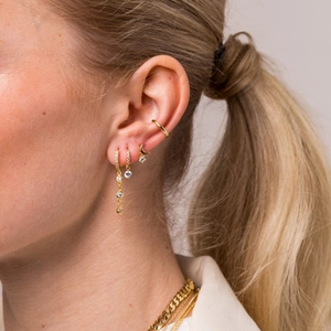Close-up of S925 silver hoop earrings with zircon dangles and gold chain necklaces