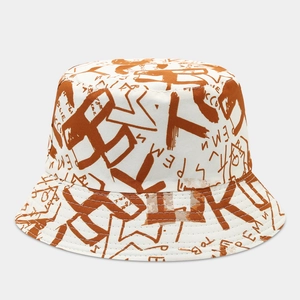Detail of flat top bucket hat with brown graffiti print and neat stitching on canvas