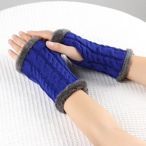Close-up of blue cable knit fingerless gloves with grey faux fur trim on a white surface