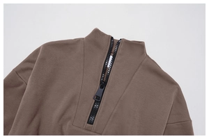 Detail of the high-quality black zipper and stand collar on this taupe sports sweatshirt