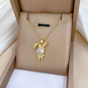 Close-up of a golden bunny pendant with a large zircon stone and sparkling pavé details
