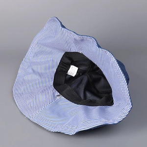 Inside view of striped sun hat with breathable black mesh lining and sweatband detail