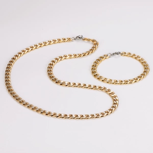 Detail of two-tone gold and silver 7mm stainless steel NK curb chain necklace and bracelet