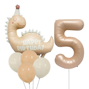 Detail of matte cream dinosaur and number 5 foil balloons for birthday party decor