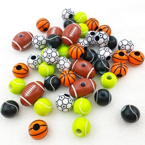 Detailed view of assorted acrylic sports beads including rugby, basketball and soccer balls