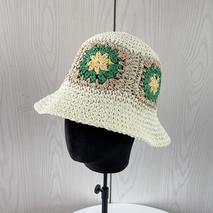 Detailed close-up of handmade crochet bucket hat with colorful flower patterns