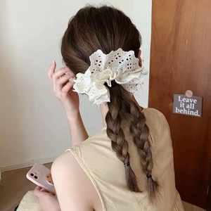 White lace hollow embroidery hair scrunchie shown on a braided hairstyle back view