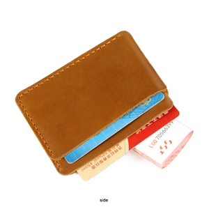 Macro shot of brown crazy horse leather card holder with hand-stitched detailing