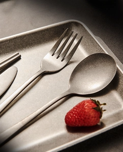 Detailed close-up of vintage snowflake grey stainless steel cutlery with a matte texture