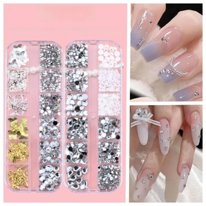 Macro detail of mixed nail art charms with butterfly, pearl, and star accents in a grid box