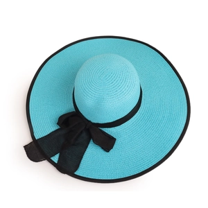 Top view detail of woven blue sun hat featuring a large black mesh bow and wide brim