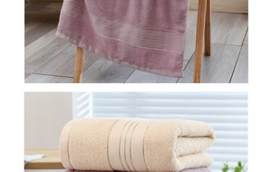 Detail showing the thick texture and soft cotton fibers of purple and beige bath towels