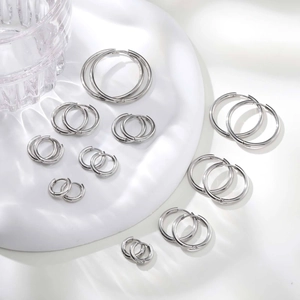 Detailed set of silver stainless steel hoop earrings in various sizes on white display