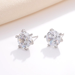 Macro side view of silver cubic zirconia stud earrings with classic four-prong setting