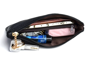 Top view of a black textured clutch showing interior space with a zipper and metal keyring