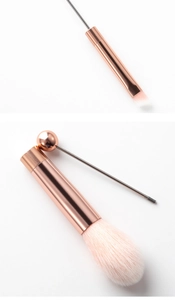 Detail of rose gold DIY beaded makeup brush set with large powder brush and metal rod