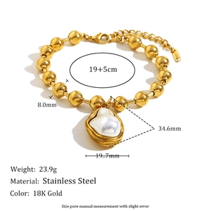 Detail view of 18K gold plated stainless steel beads and large baroque pearl pendant charm