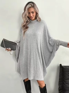 Elegant oversized grey knit turtleneck dress with wide batwing sleeves and ribbed texture