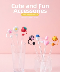 Macro shot of 7 cute cartoon silicone straw covers including cat paw and daisy on glass straws