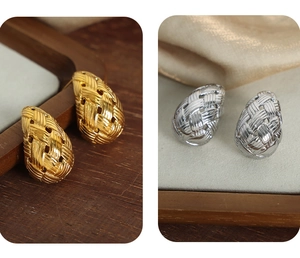 Macro detail of tear-drop earrings with woven texture in gold and silver plating