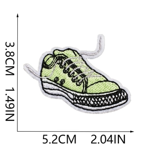 Detail view of green sneaker embroidery patch showing 5.2cm x 3.8cm dimensions