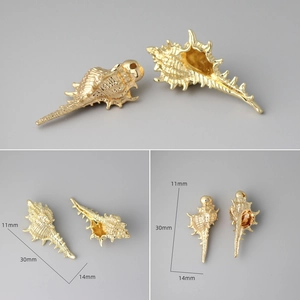 Macro view of a 30mm 18k gold plated conch shell charm showing size and spiral texture
