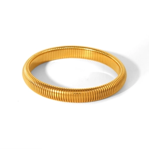 Macro detail of vintage-style golden stretch snake bone bracelet with metallic texture
