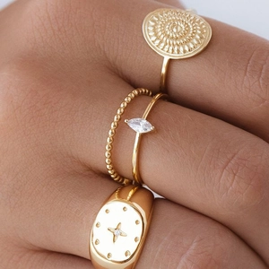 Set of four 18k gold plated bohemian rings featuring mandala and celestial star patterns