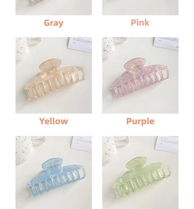 Macro shot of colorful iridescent resin hair claws in grey, pink, yellow, and purple